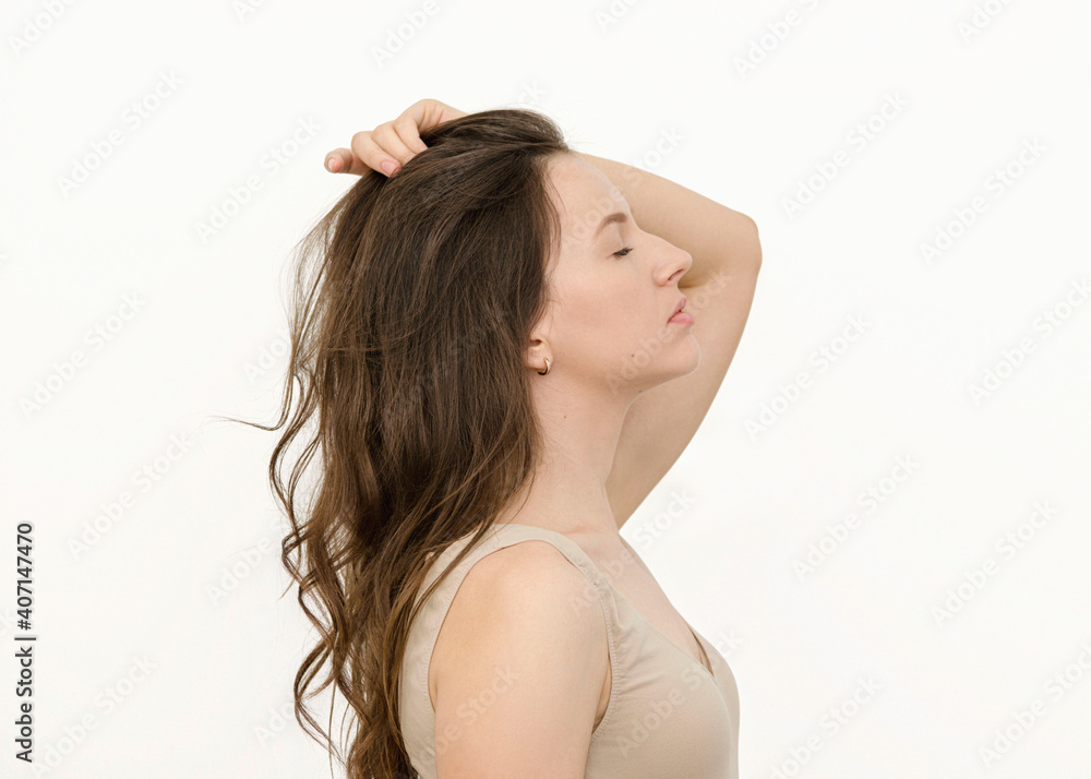 portrait of a woman brunette holds her hair