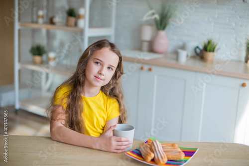 Happy curly girl in yellow shirt in the kitchen  © Andreshkova Nastya