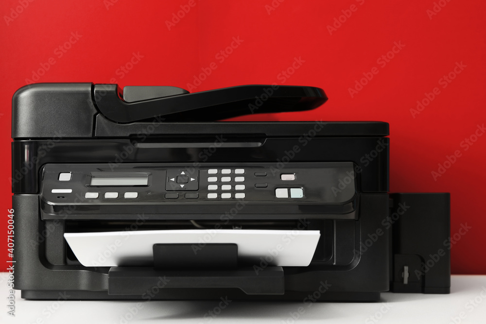 Modern printer with paper on red background Modern printer with paper on red background