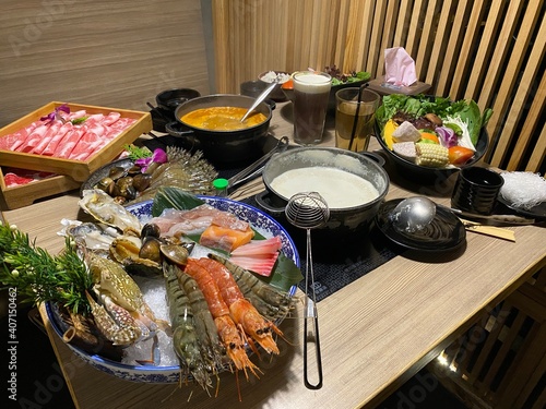 Taiwanese hot pot has become a national pastime fit for anyone, the restaurant provides a fine soup stock and freshly cut meat slices. The Image shows seafood, meat, vegetables, hot soup and milk soup