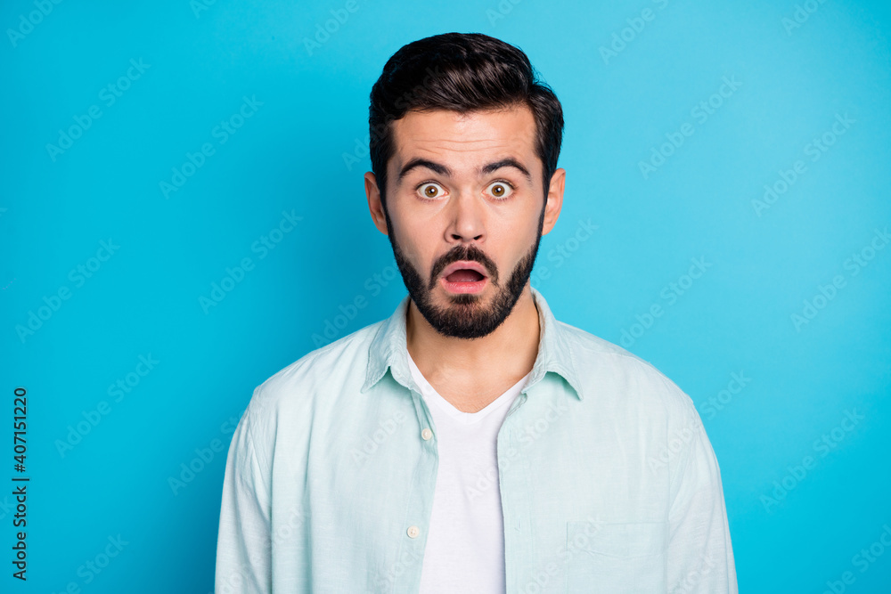 Photo of speechless young attractive surprised man open mouth stupor isolated on blue color background Photo of speechless young attractive surprised man open mouth stupor isolated on blue color background