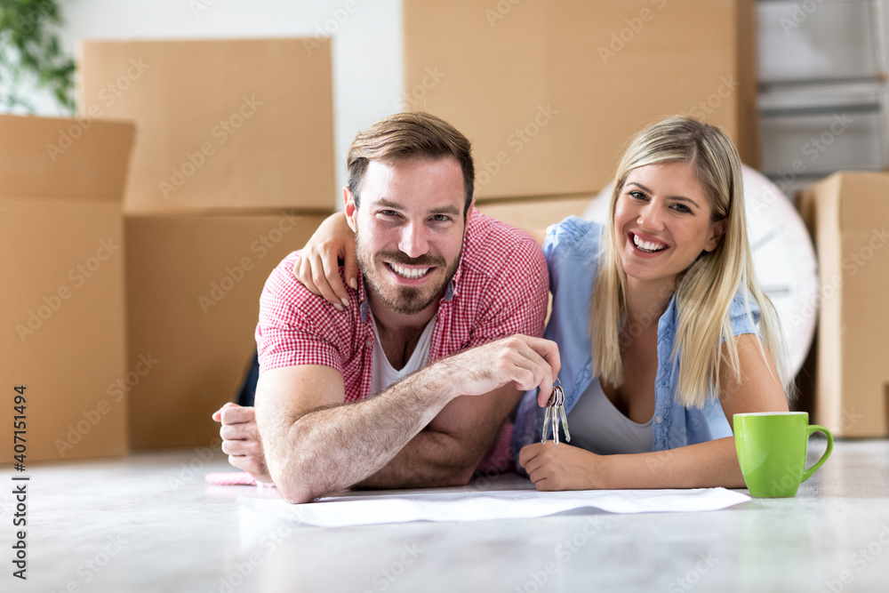 Young couple celebrating moving to new home Young couple celebrating moving to new home