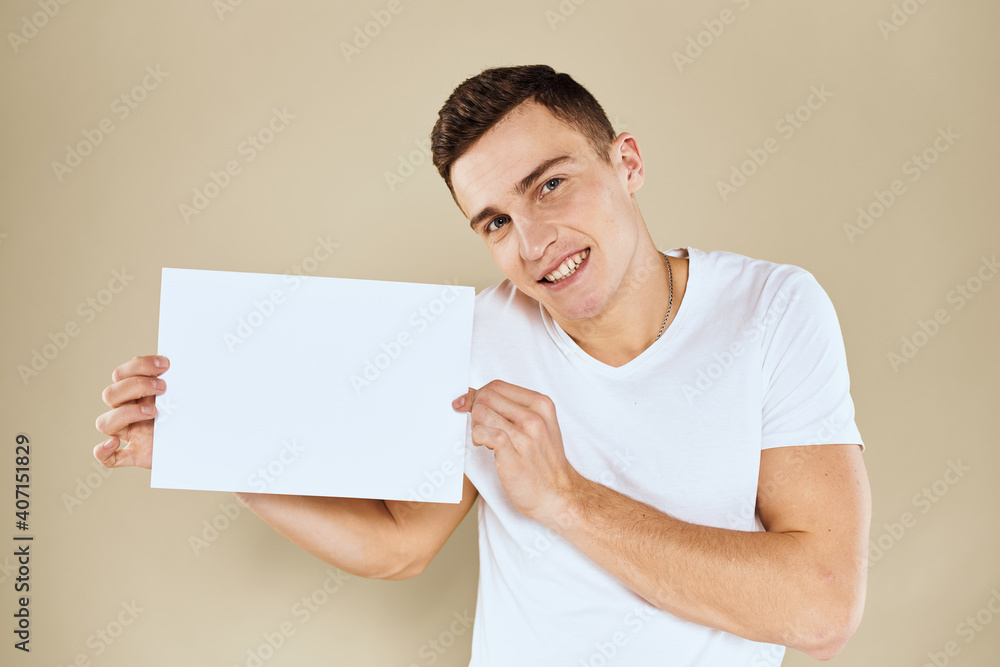 man in white t-shirt sheet of paper in hands Copy Space cropped view beige background man in white t-shirt sheet of paper in hands Copy Space cropped view beige background