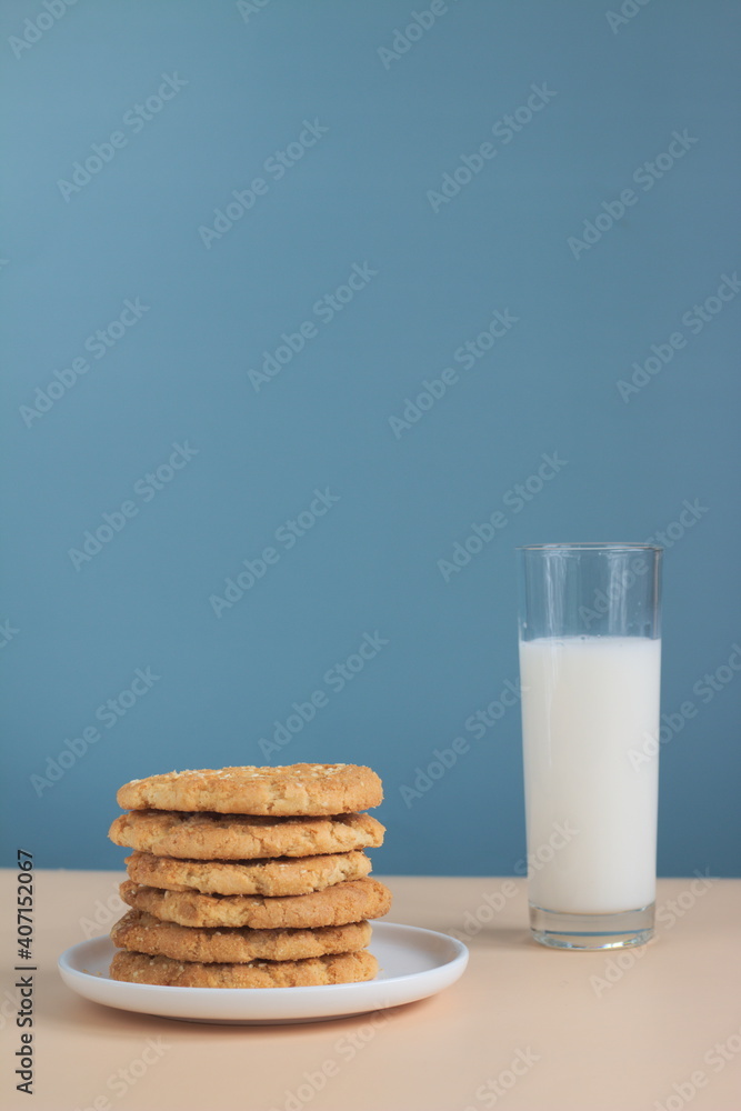 Stacked cookies in white porcelain plate and milk on the table Stacked cookies in white porcelain plate and milk on the table