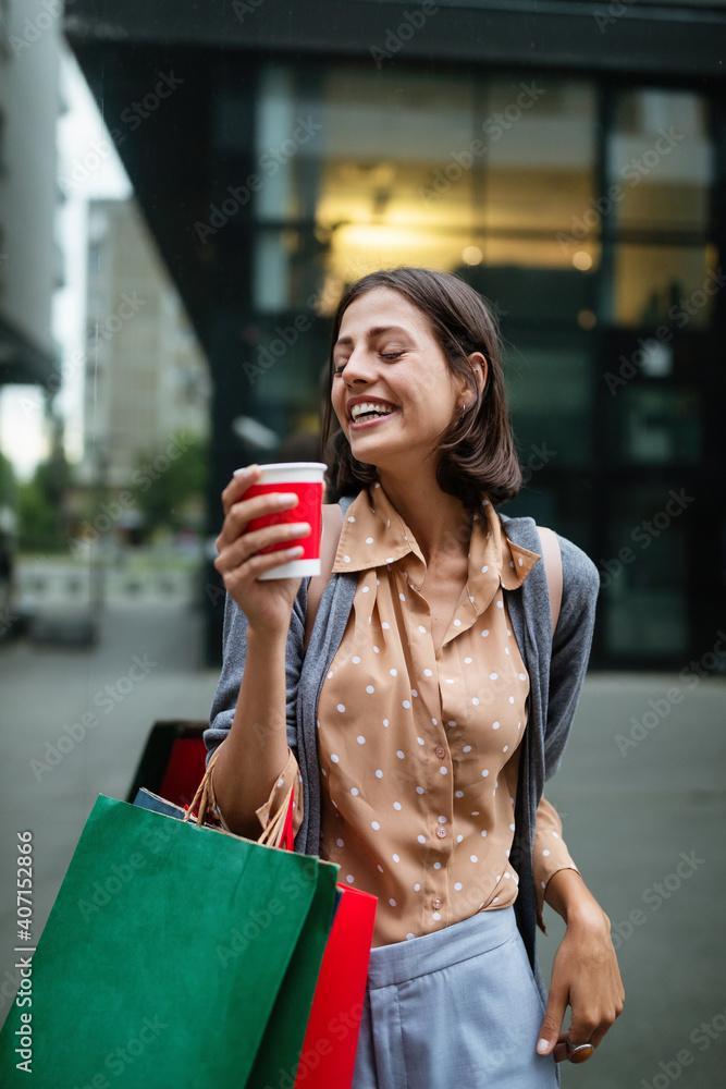Fototapeta premium Happy woman with shopping bags enjoying in shopping. Consumerism, shopping, lifestyle concept