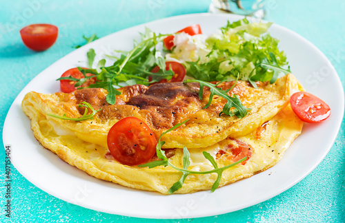 Breakfast. Omelette with tomatoes, cheese and arugula on white plate.  Frittata - italian omelet. Ketogenic, keto food.