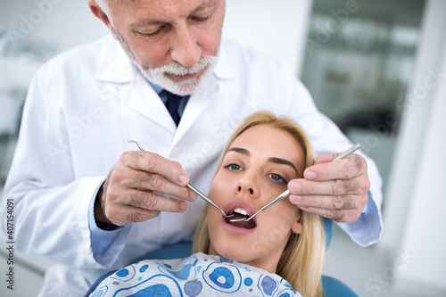 Dentist examining a patient s teeth in the dentist