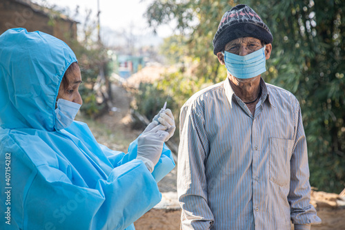 Photography Doctor's hands in surgical gloves preparing COVID-19 vaccine for male patient in