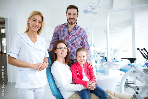 Family with a smiling young dentist