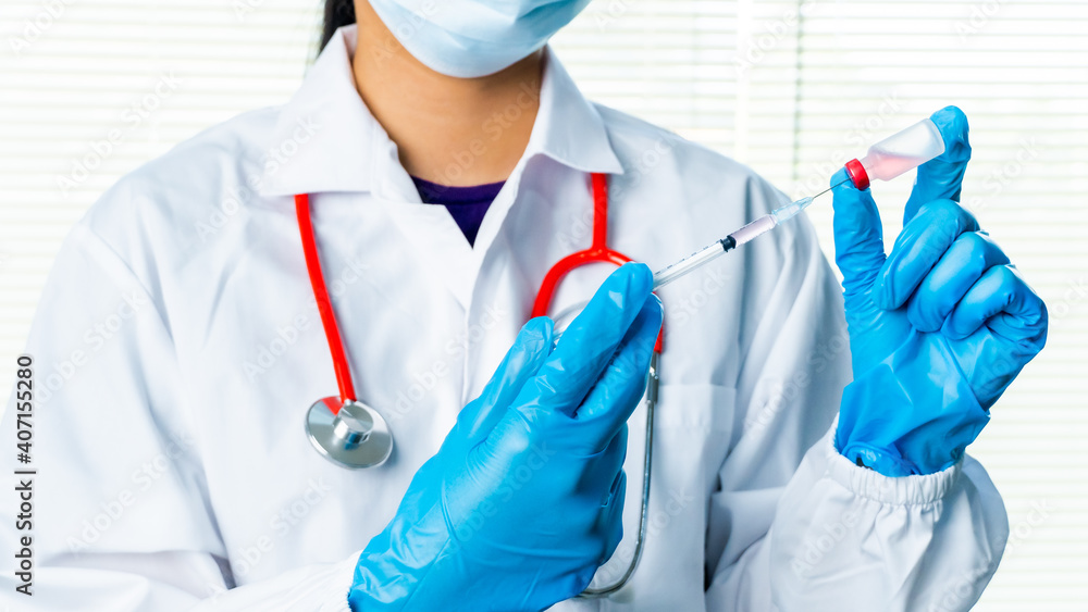 Doctors or scientists are carrying syringes with liquid vaccines for young and old to. prevent COVID-19 in the laboratory. Concept COVID-19 vaccine. Doctors or scientists are carrying syringes with liquid vaccines for young and old to. prevent COVID-19 in the laboratory. Concept COVID-19 vaccine.