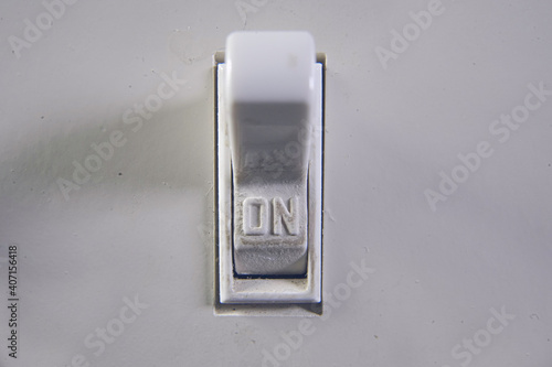 Macro Close Up Of A Light Switch Turned To On