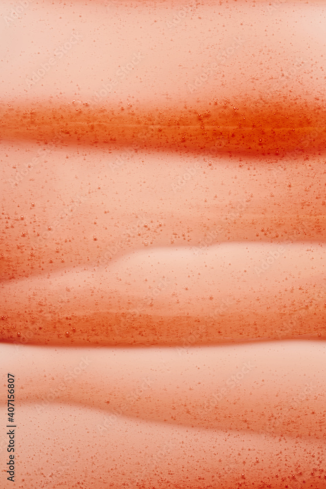 The texture of the red transparent cosmetic gel. Abstract background The texture of the red transparent cosmetic gel. Abstract background