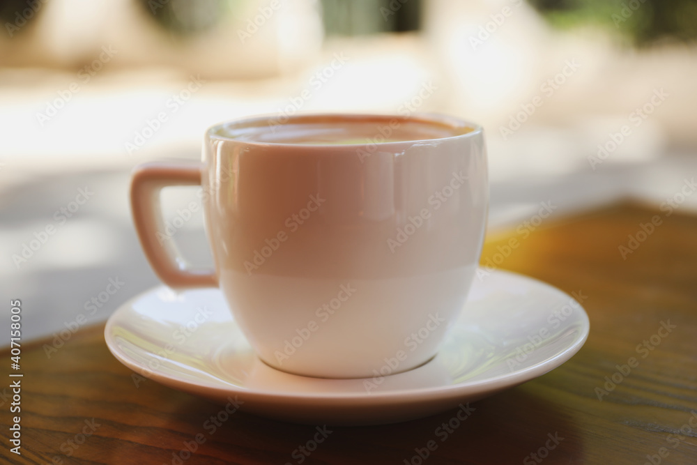 Aromatic coffee on wooden table outdoors, closeup