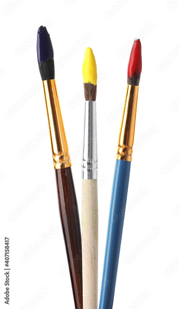 Different brushes with paints on white background Different brushes with paints on white background