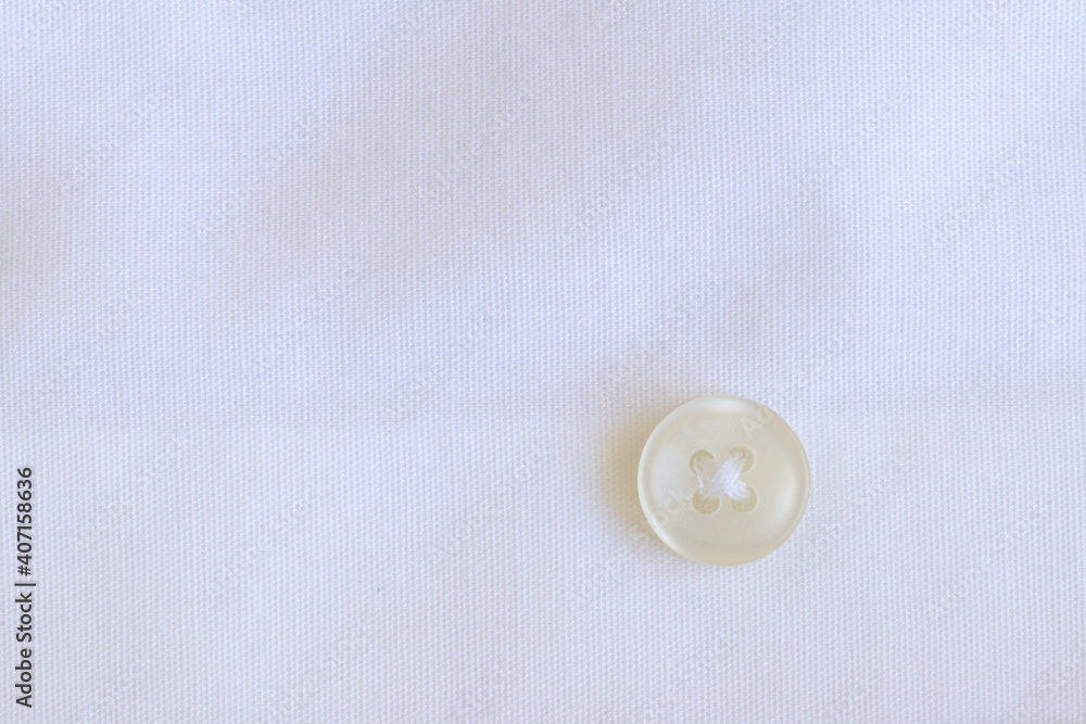 The texture of the fabric with a button for clothes. The texture of the fabric with a button for clothes.