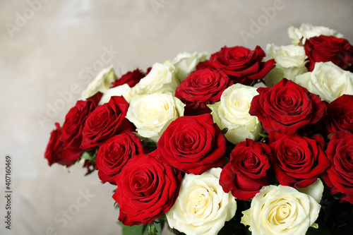 Luxury bouquet of fresh roses on beige background  closeup