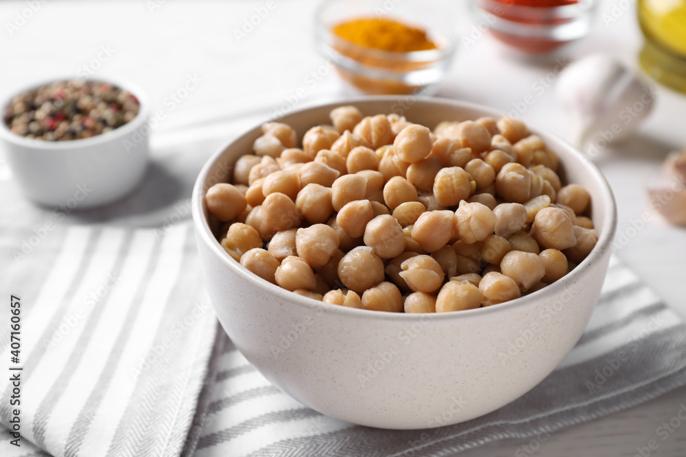 Bowl with delicious chickpeas on table, closeup Bowl with delicious chickpeas on table, closeup