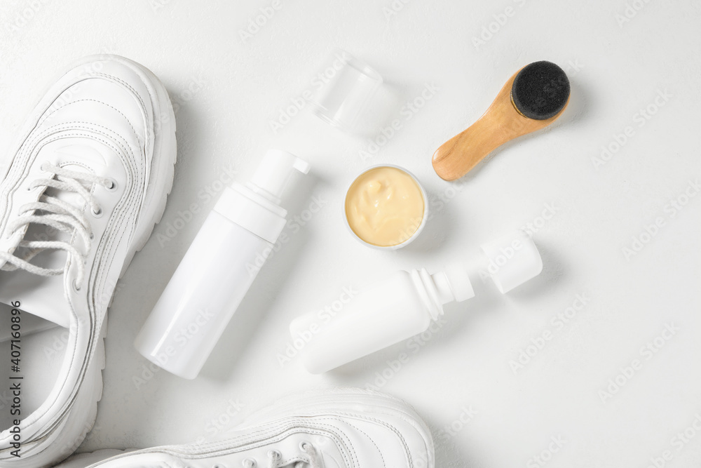 Flat lay composition with stylish footwear and shoe care accessories on white background Flat lay composition with stylish footwear and shoe care accessories on white background