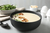 Delicious cream soup with mushrooms on light table