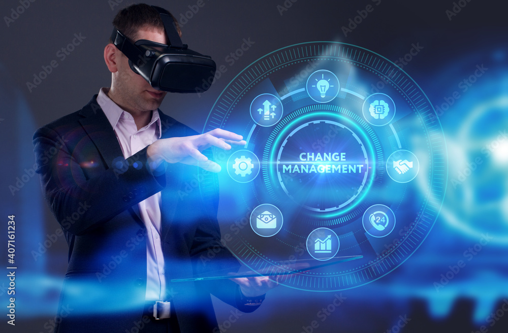 Business, Technology, Internet and network concept. Young businessman working on a virtual screen of the future and sees the inscription: Change management Business, Technology, Internet and network concept. Young businessman working on a virtual screen of the future and sees the inscription: Change management