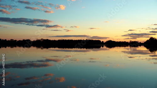 Panorama of the lake at sunset. The lake reflects the sky