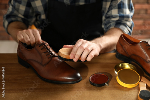 Master taking care of shoes in his workshop, closeup