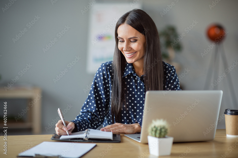 Photo of brunette young business woman white plan notebook sit table laptop office job indoors workstation - obrazy, fototapety, plakaty 