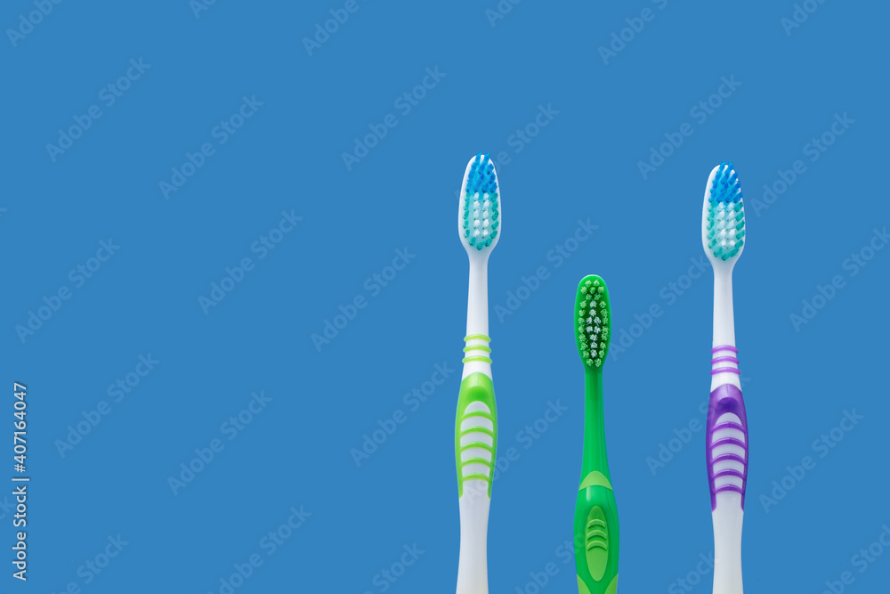 Family concept with two adult toothbrushes and small green child toothbrush Family concept with two adult toothbrushes and small green child toothbrush