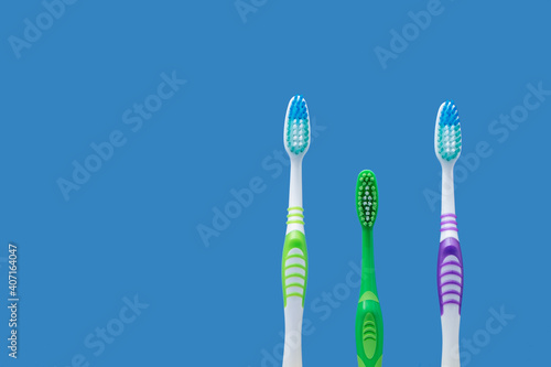 Family concept with two adult toothbrushes and small green child toothbrush