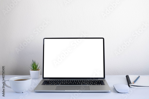 White office desk table with keyboard of laptop, coffee cup and notebook, mouse computer with equipment office supplies. Business and finance concept. Workplace, Flat lay with blank copy space.