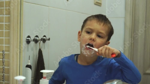 Little kid boy brushing teeth