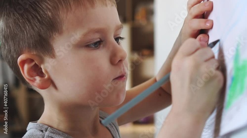 Little child draws with a pencil