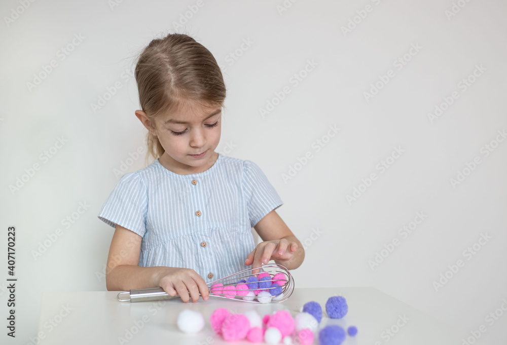 kitchen whisk child fine motor skills sensory activity is fun way for toddlers to practice fine motor hand coordination. kitchen whisk child fine motor skills sensory activity is fun way for toddlers to practice fine motor hand coordination.