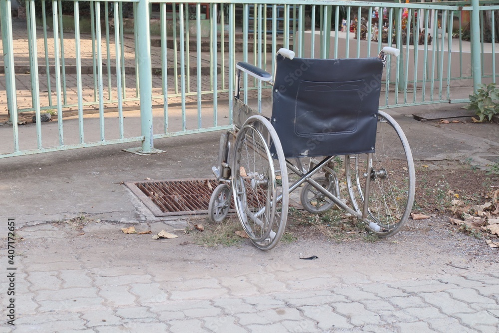 Wheelchairs parked on an outdoor street, optional focus.