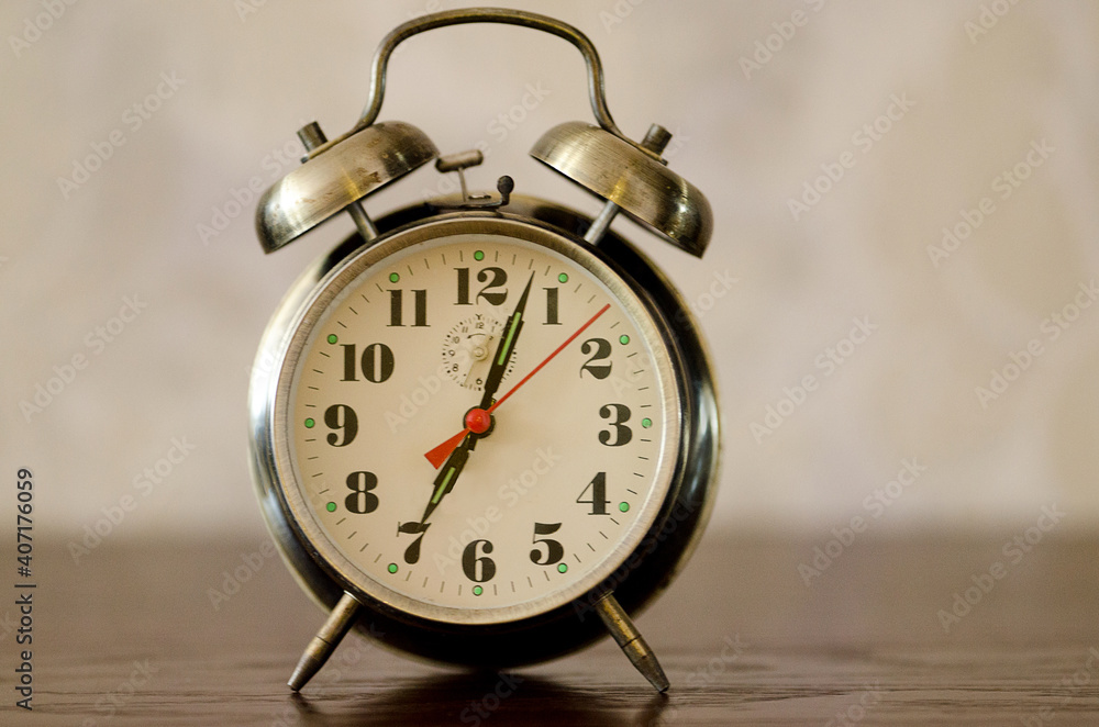Alarm clock standing on the bedside table. Alarm clock standing on the bedside table.
