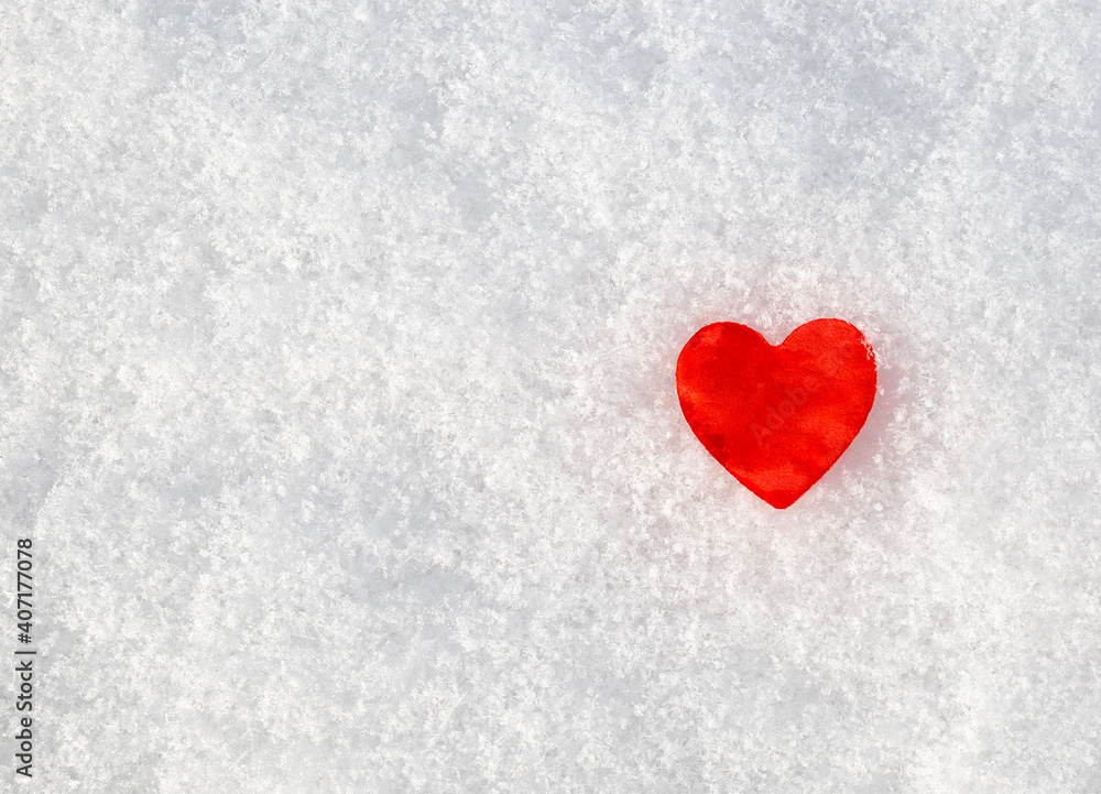 concept Valentines Day: red heart in the snow