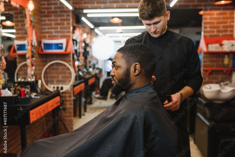 Young African-american man visiting barbershop
