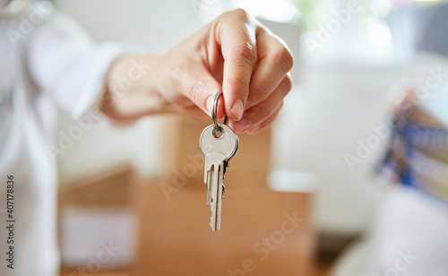 Hand holds house key of a property