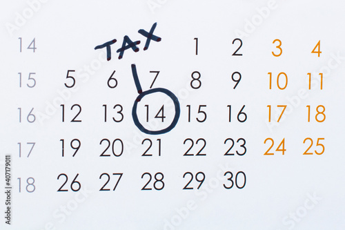 Manual written reminder of the tax return in the calendar. Pay tax