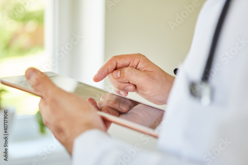 Doctor s finger operates the touchscreen on the tablet
