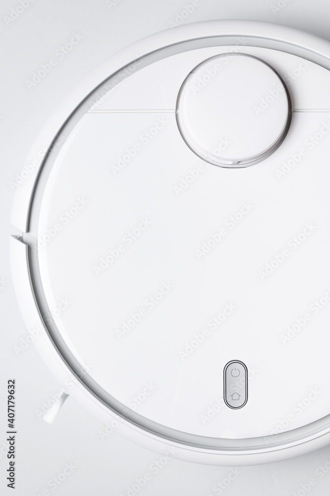 Modern robot vacuum cleaner on gray background flat lay. New technologies, quick house cleaning, automatic robot assistant. Free time to relax. Future technology, smart appliance for cleaning house Modern robot vacuum cleaner on gray background flat lay. New technologies, quick house cleaning, automatic robot assistant. Free time to relax. Future technology, smart appliance for cleaning house
