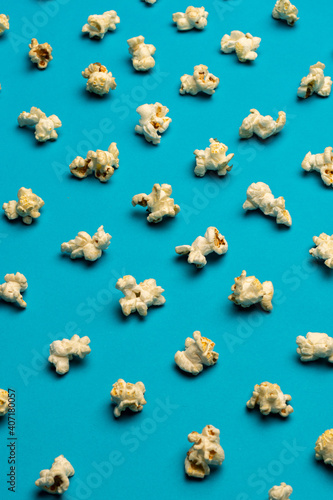 Repeat abstract pattern image of popcorn on a blue background, marketing design image for website or social media