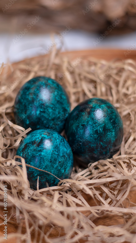 Dyed eggs in dark tidewater green tones. Easter festive background, open card, eggs close-up. Table setting for the Easter holiday. Christ is Risen Easter holiday. Dyed eggs in dark tidewater green tones. Easter festive background, open card, eggs close-up. Table setting for the Easter holiday. Christ is Risen Easter holiday.