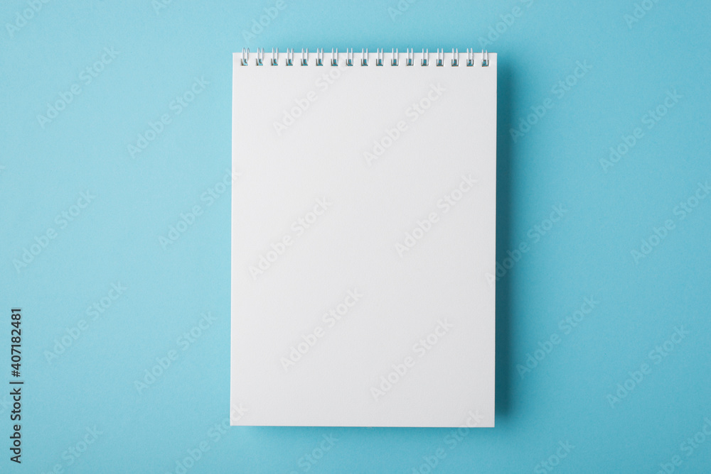 Above flat lay overhead close up view photo of clear open spiral notepad for letter document isolated light backdrop Above flat lay overhead close up view photo of clear open spiral notepad for letter document isolated light backdrop