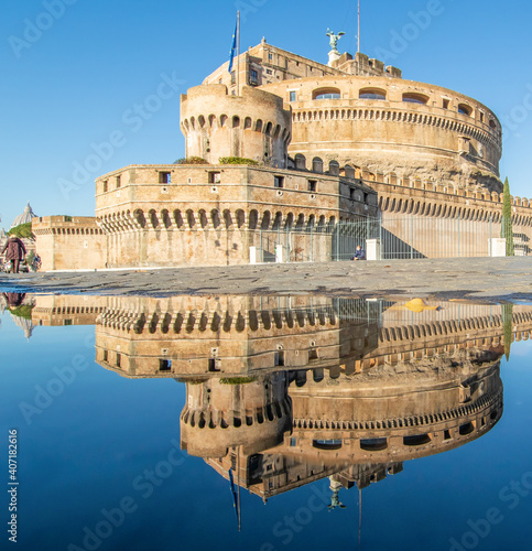 Rome, Italy - in Winter time, frequent rain showers create pools in which the wonderful Old Town of Rome reflect like in a mirror. Here in particular Castel Sant'Angelo