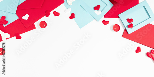 Creative Valentine's Day concept. Envelopes, valentines, white and red hearts confetti on white background. Flat lay, top view, copy space