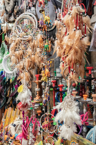 a lot of different colorful dreamcatchers and hookahs at street market 