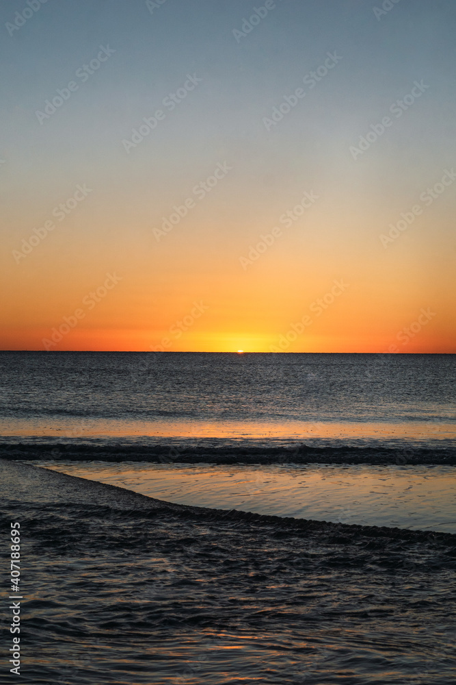 Last moment of the sun setting at sunset over the sea Last moment of the sun setting at sunset over the sea