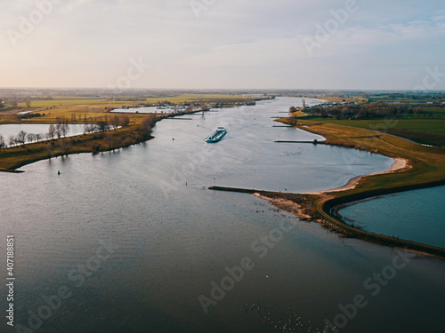 Photography Aerial drone view of the ship passing at the canal in the Netherlands