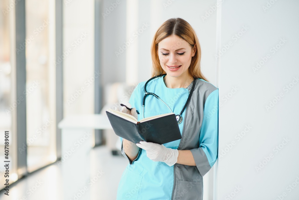 Beautiful smiling doctor woman in medical gown Beautiful smiling doctor woman in medical gown